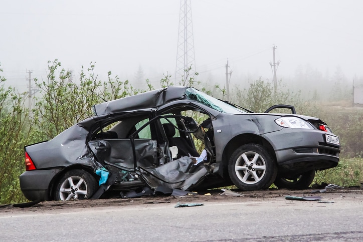 Grey motor car Toyota Corolla laying after a heavy crash at the city street.