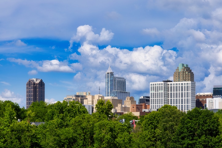 A beautiful downtown cityscape of Raleigh, North Carolina in Spring under a nice blue sky with puffy clouds.